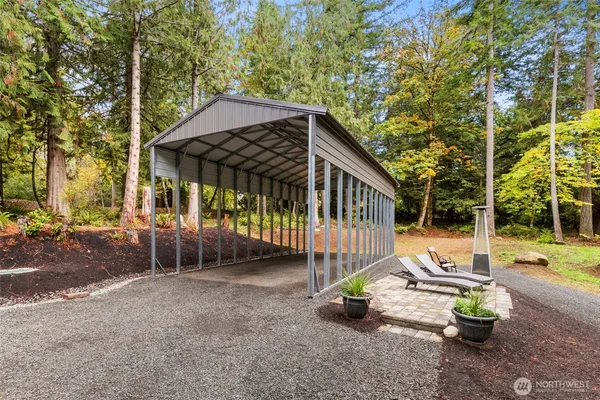 a view of a house with backyard and sitting area