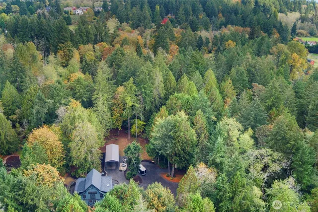 an aerial view of a house with a yard
