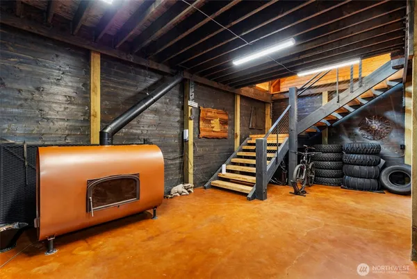 a view of an empty room with stairs wooden floor and windows