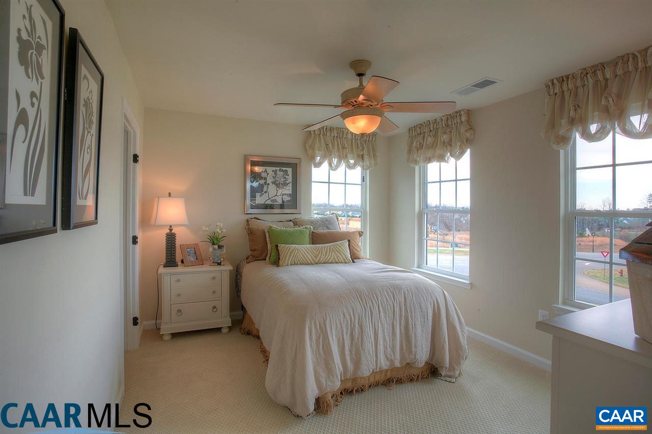 18 Ridgemont Road Ruckersville, VA 22968 - Photo 14 of 26 a bedroom with a bed and a chandelier