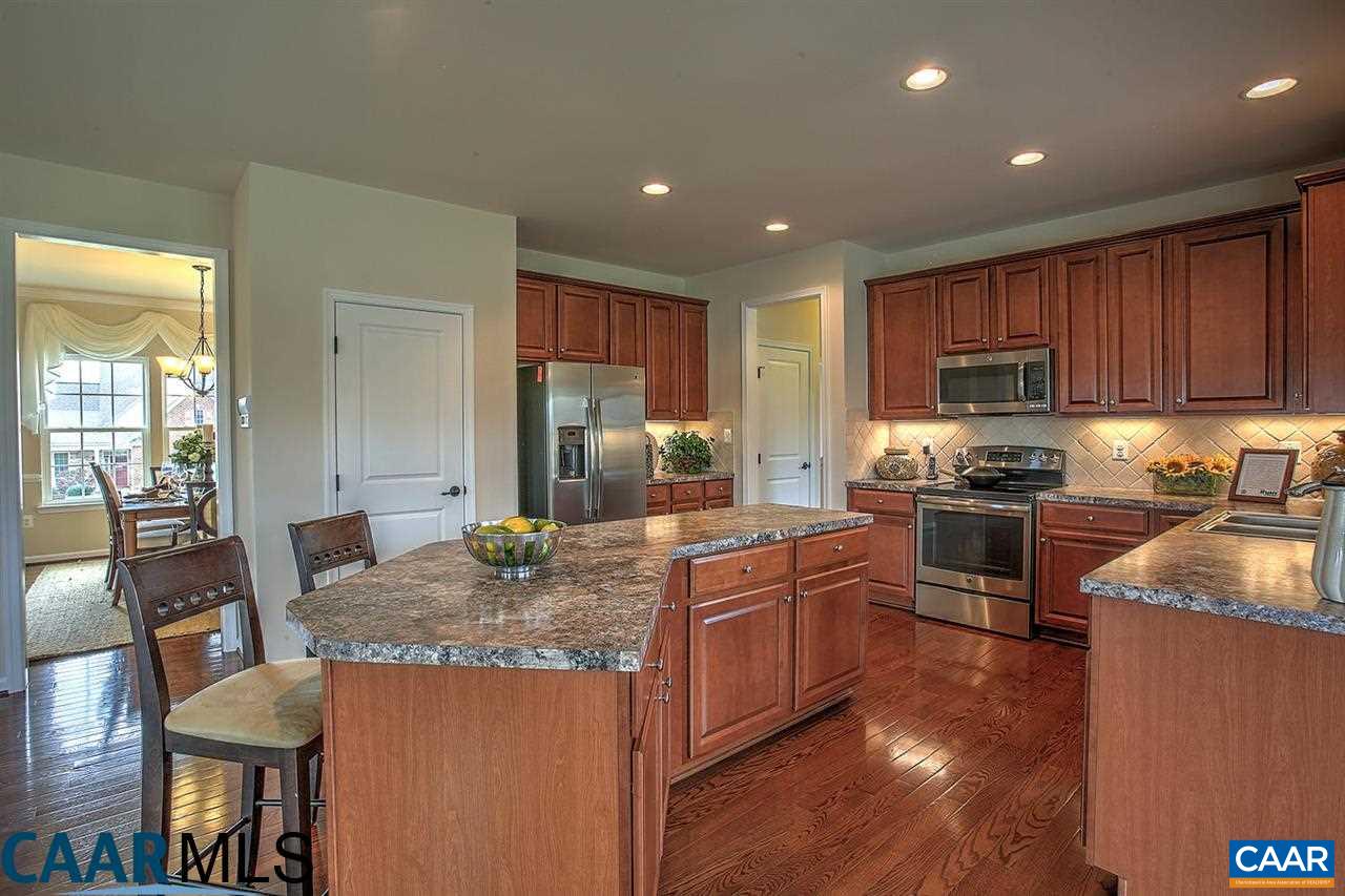 18 Ridgemont Road Ruckersville, VA 22968 - Photo 8 of 26 a kitchen with granite countertop kitchen island wooden cabinets and stainless steel appliances