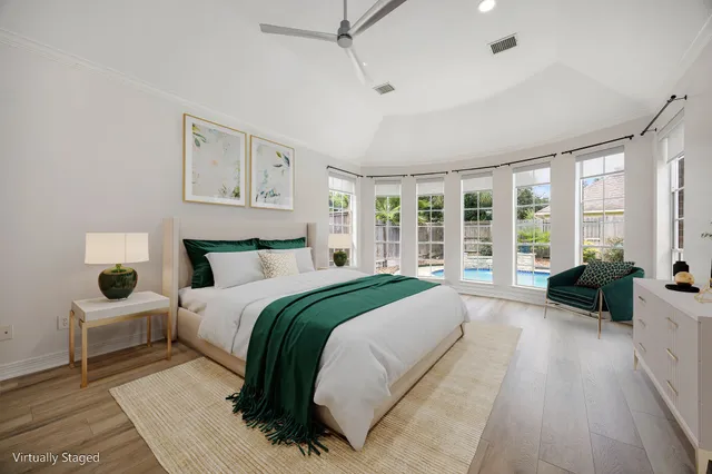 a spacious bedroom with a large bed and a large window