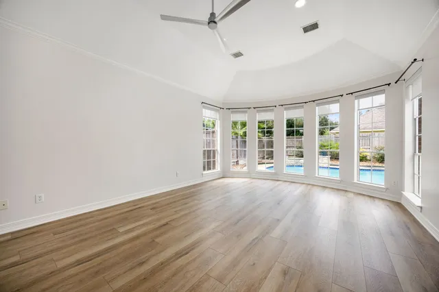 wooden floor in an empty room with a window