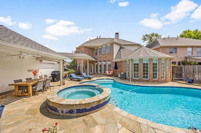 a view of a house with swimming pool and porch