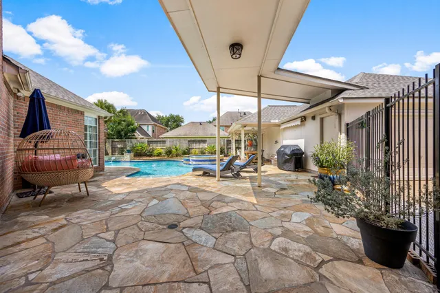 a view of a patio with table and chairs and potted plants