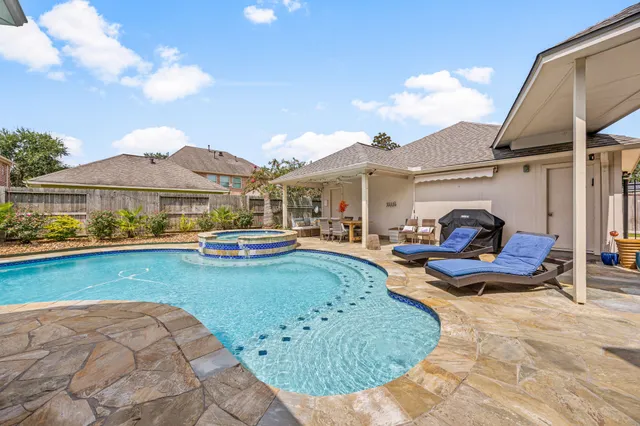 a view of a swimming pool with lounge chair