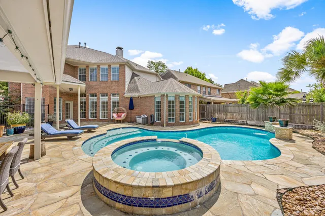 a view of a house with swimming pool and sitting area