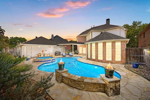 a view of a house with swimming pool and sitting area