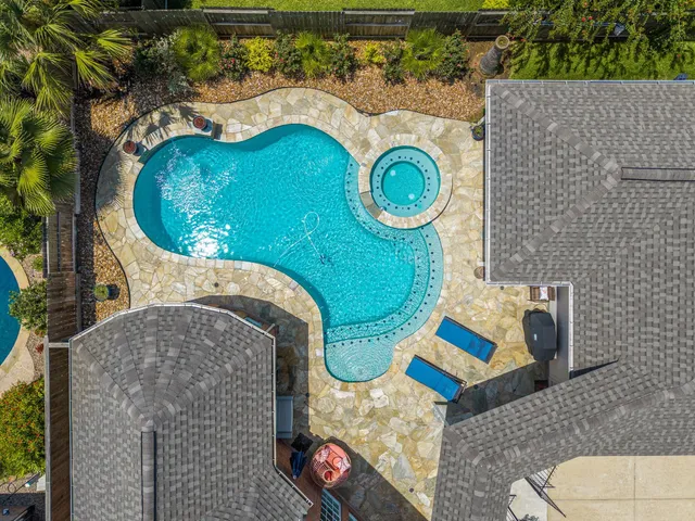 an aerial view of a house with swimming pool and outdoor space