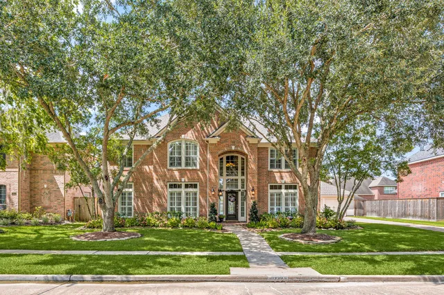 a front view of a building with trees