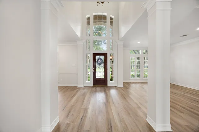 wooden floor in an empty room with a window