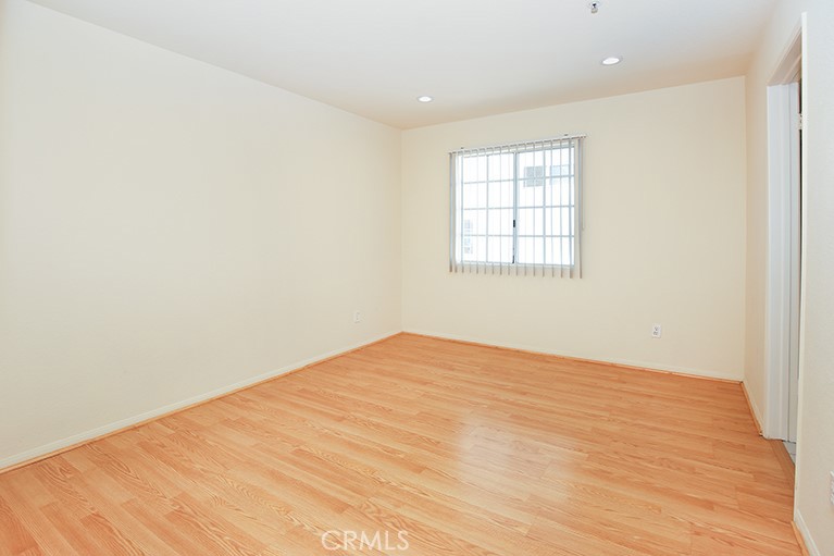 223 North Adams Street, Unit 6 Glendale, CA 91206 - Photo 12 of 20 an empty room with wooden floor and windows