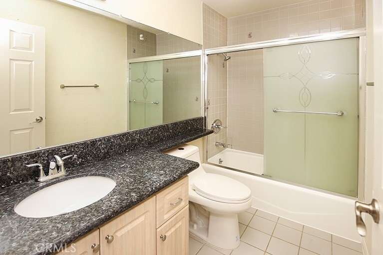 223 North Adams Street, Unit 6 Glendale, CA 91206 - Photo 16 of 20 a bathroom with a granite countertop sink toilet and shower