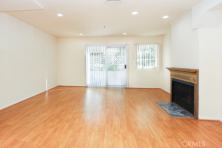 223 North Adams Street, Unit 6 Glendale, CA 91206 - Photo 3 of 20 a view of empty room with wooden floor and fireplace