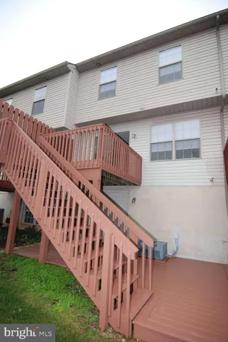 a view of a house with backyard and deck