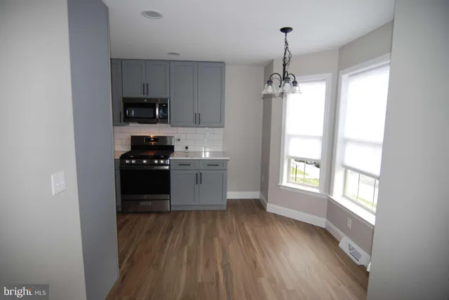 a kitchen with stainless steel appliances a refrigerator sink and microwave