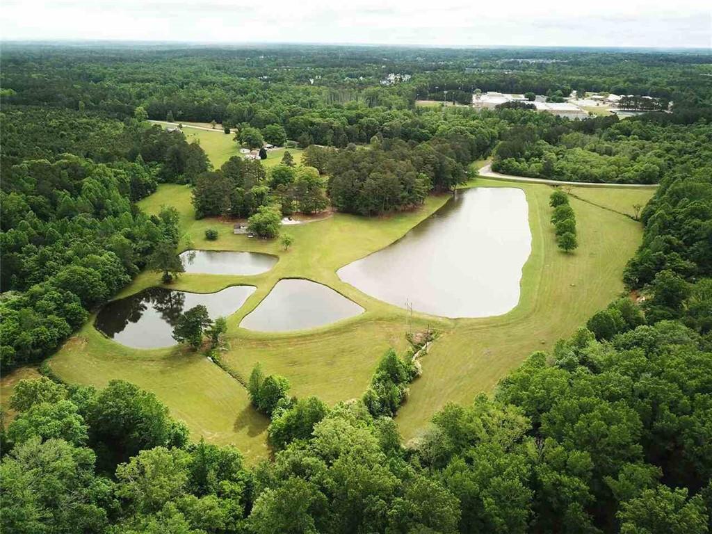 7275 Bishop Road Fairburn, GA 30213 - Photo 6 of 11 an aerial view of residential houses with outdoor space and swimming pool