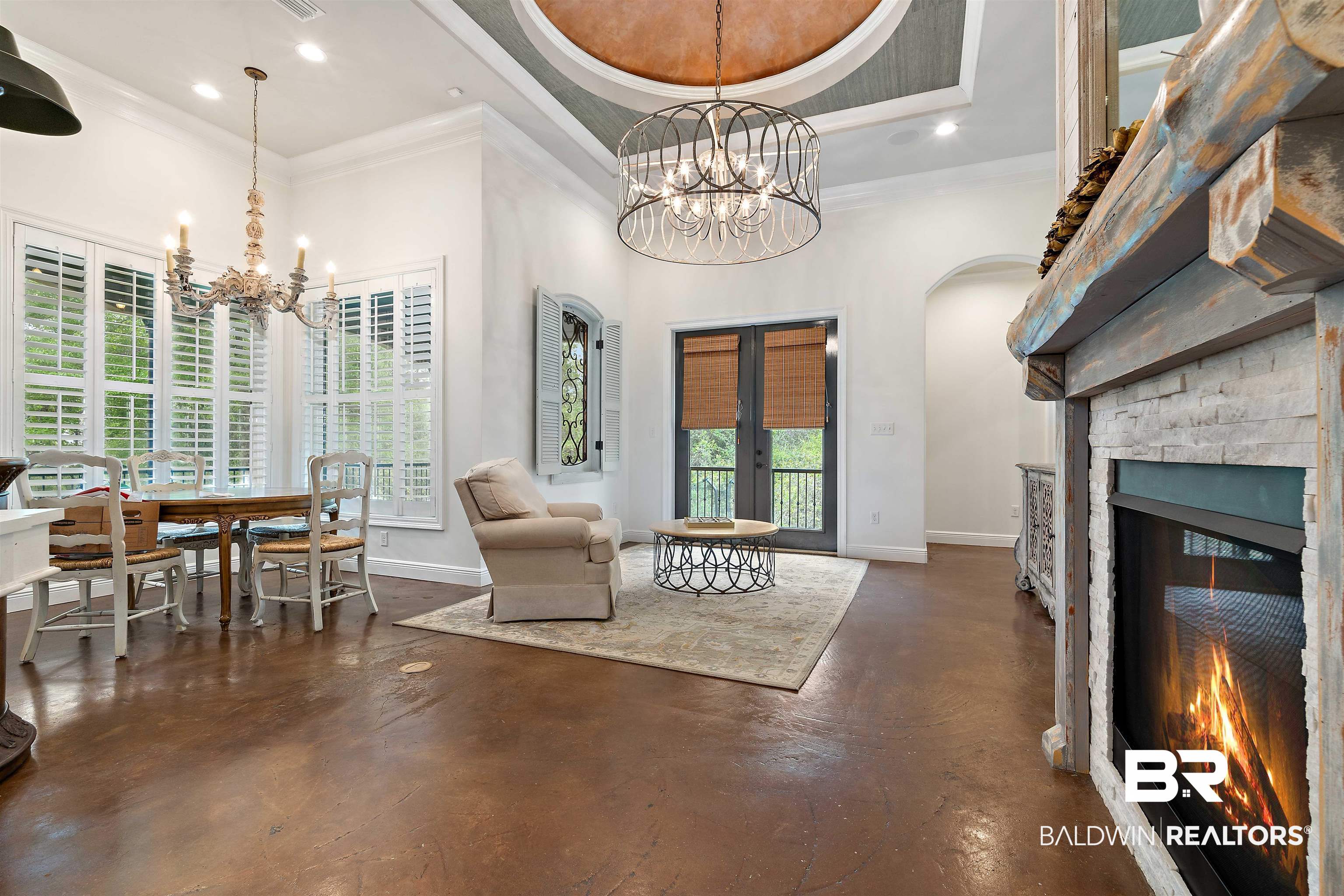 3584 Rue Royal Mobile, AL 36693 - Photo 6 of 35 Interior space with baseboards, a chandelier, a fireplace, and finished concrete flooring