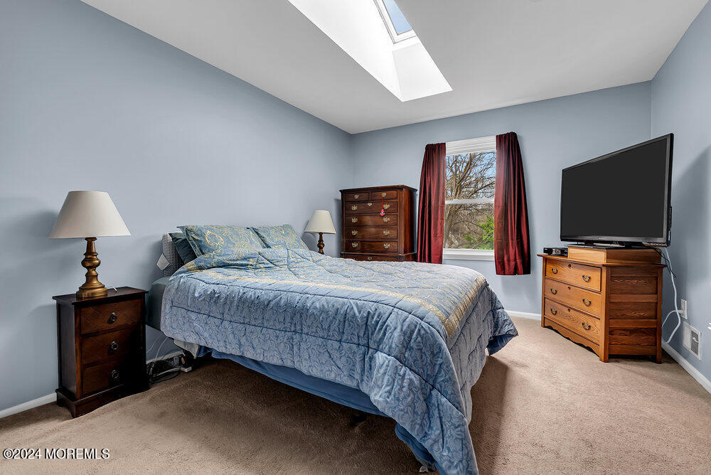 92 Concord Circle Howell, NJ 07731 - Photo 13 of 23 a bedroom with a bed and a flat tv screen on dresser