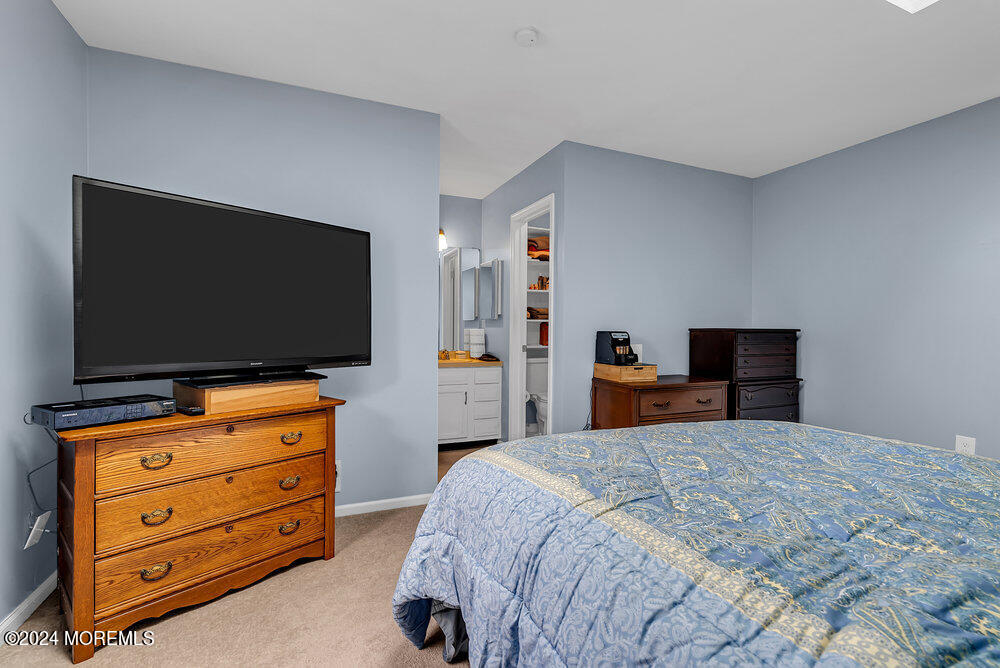 92 Concord Circle Howell, NJ 07731 - Photo 14 of 23 a bedroom with a bed and a flat screen tv