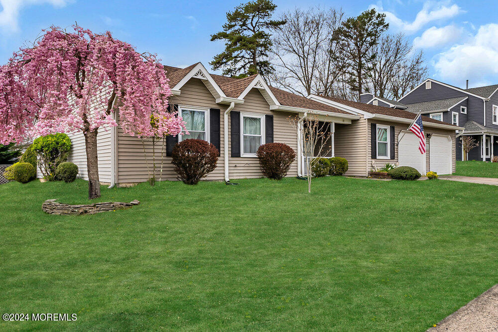 92 Concord Circle Howell, NJ 07731 - Photo 2 of 23 a front view of a house with a yard and garage