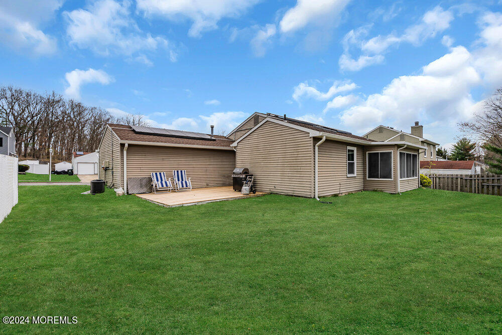 92 Concord Circle Howell, NJ 07731 - Photo 23 of 23 a view of a backyard with plants and large tree
