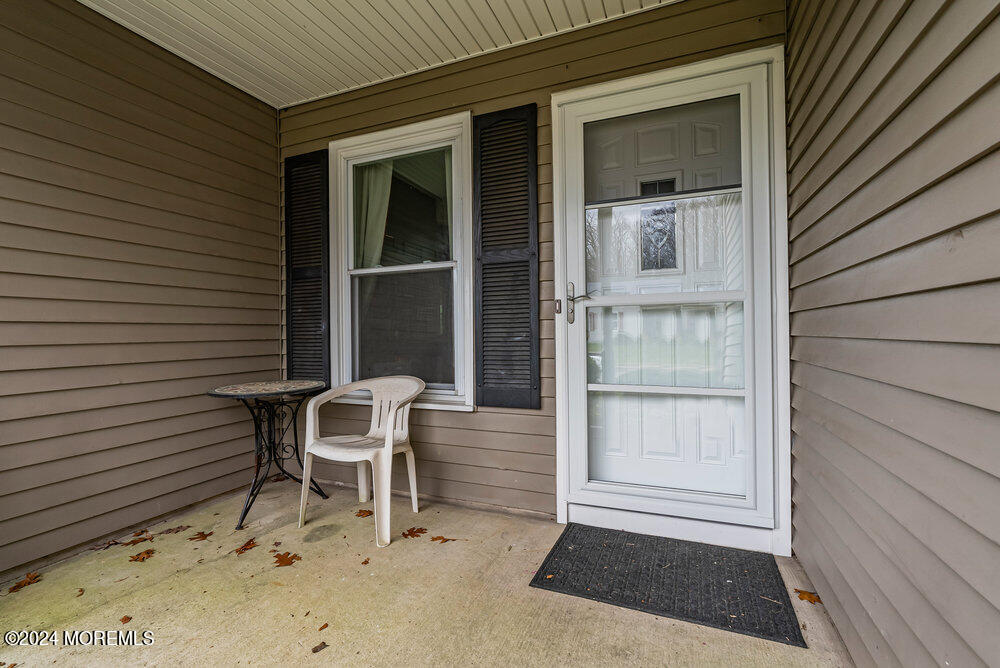 92 Concord Circle Howell, NJ 07731 - Photo 3 of 23 a chair and a table in a balcony