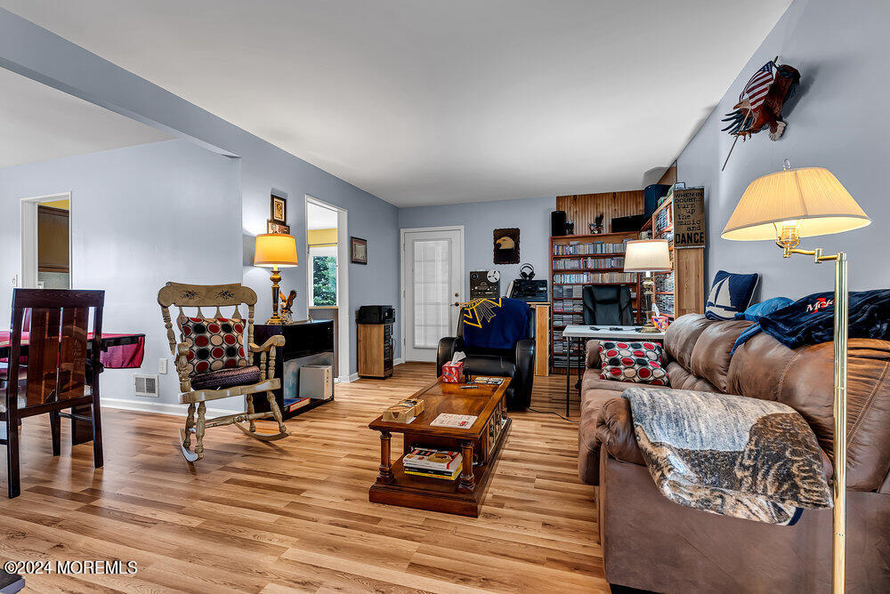 92 Concord Circle Howell, NJ 07731 - Photo 5 of 23 a living room with furniture and a dining table with wooden floor