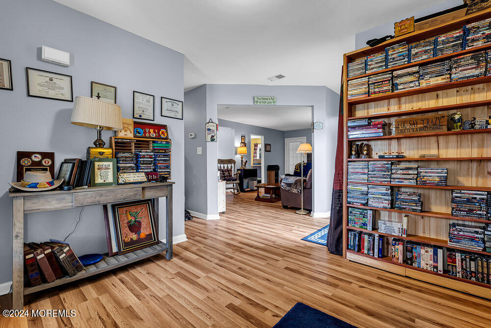92 Concord Circle Howell, NJ 07731 - Photo 7 of 23 a living room with lots of furniture and a book shelf