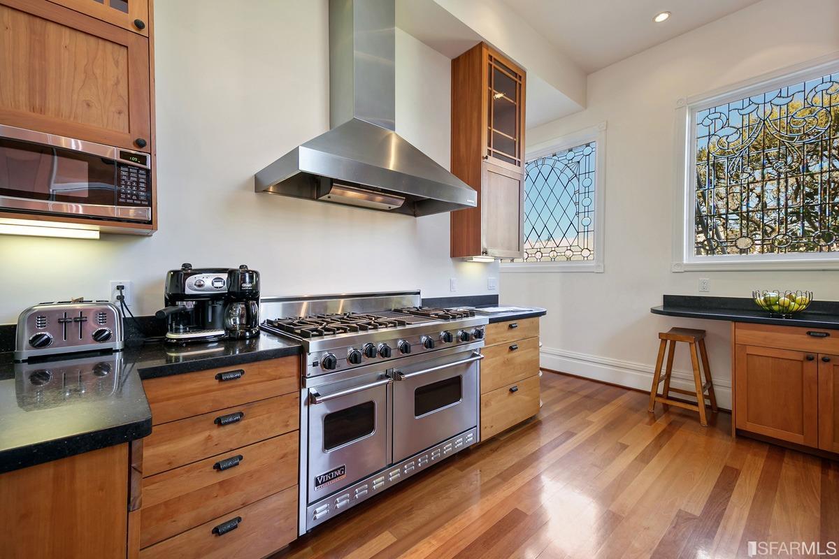 Frederick Street San Francisco, CA 94117 - Photo 20 of 61 a kitchen with stainless steel appliances a stove a sink and cabinets