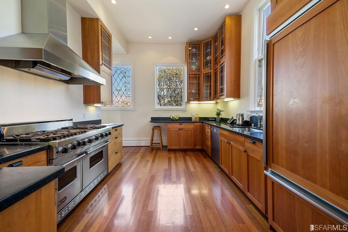 Frederick Street San Francisco, CA 94117 - Photo 21 of 61 a kitchen with wooden floors and a stove