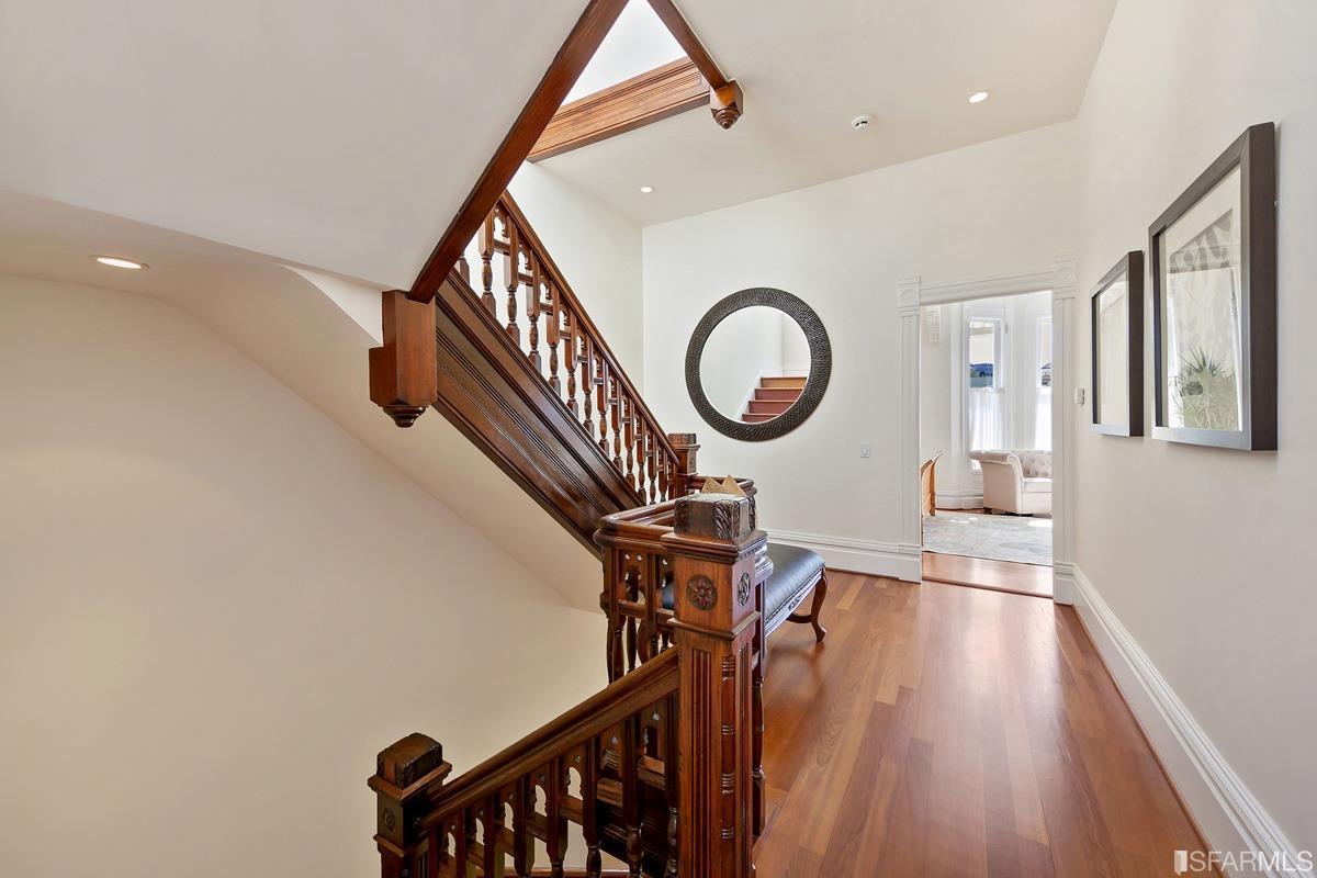 Frederick Street San Francisco, CA 94117 - Photo 25 of 61 a view of a hallway with a dining table chairs and wooden floor
