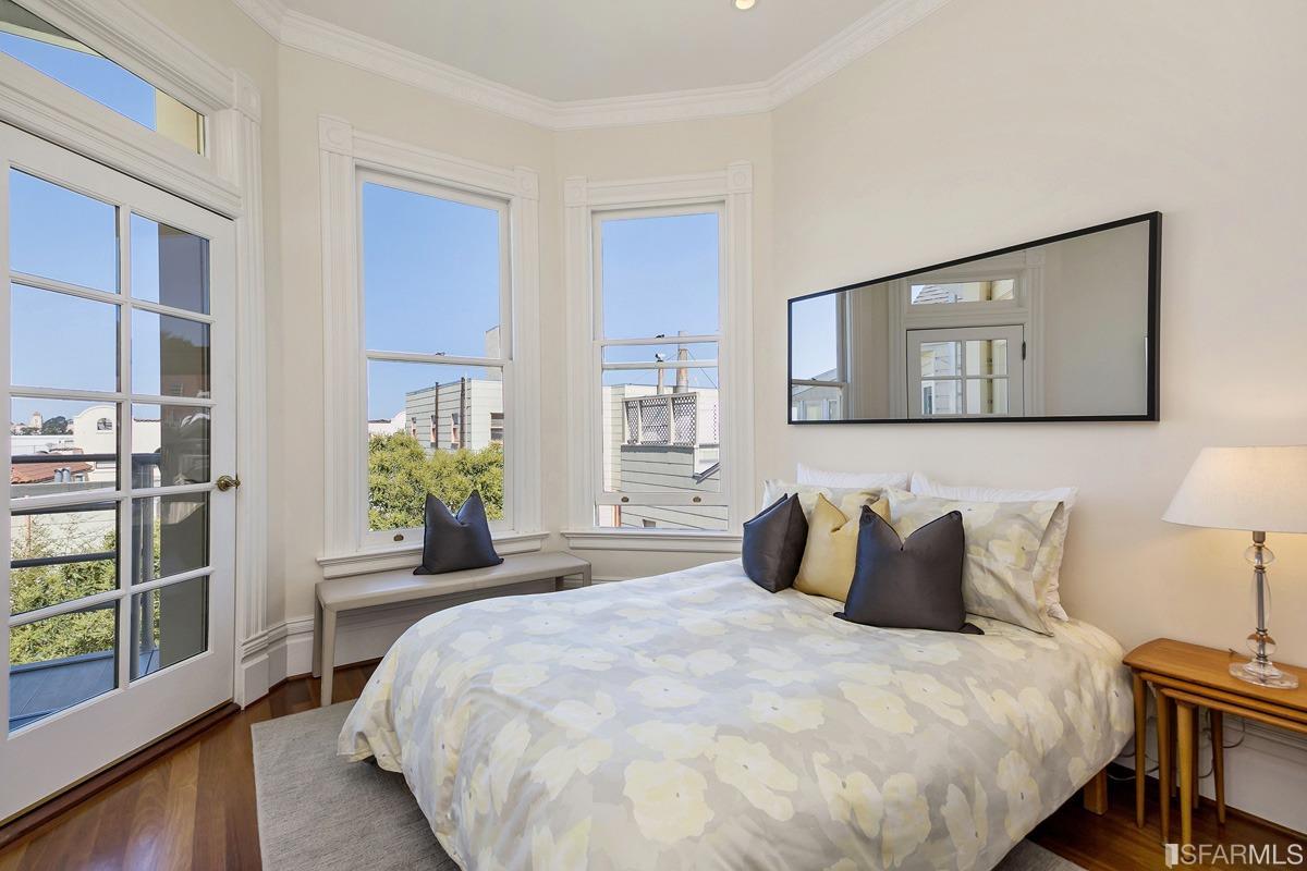 Frederick Street San Francisco, CA 94117 - Photo 35 of 61 a bedroom with a bed painting on wall and a window