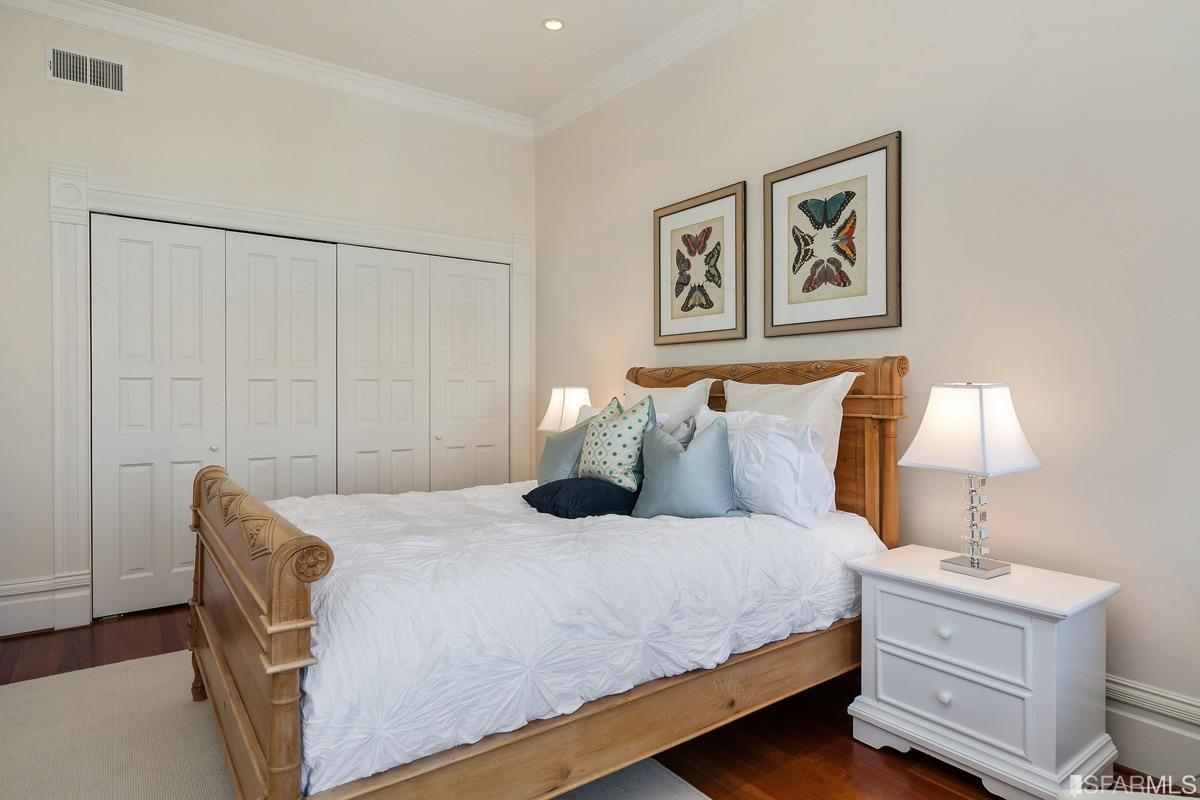 Frederick Street San Francisco, CA 94117 - Photo 39 of 61 a bedroom with a bed and a lamp on dresser