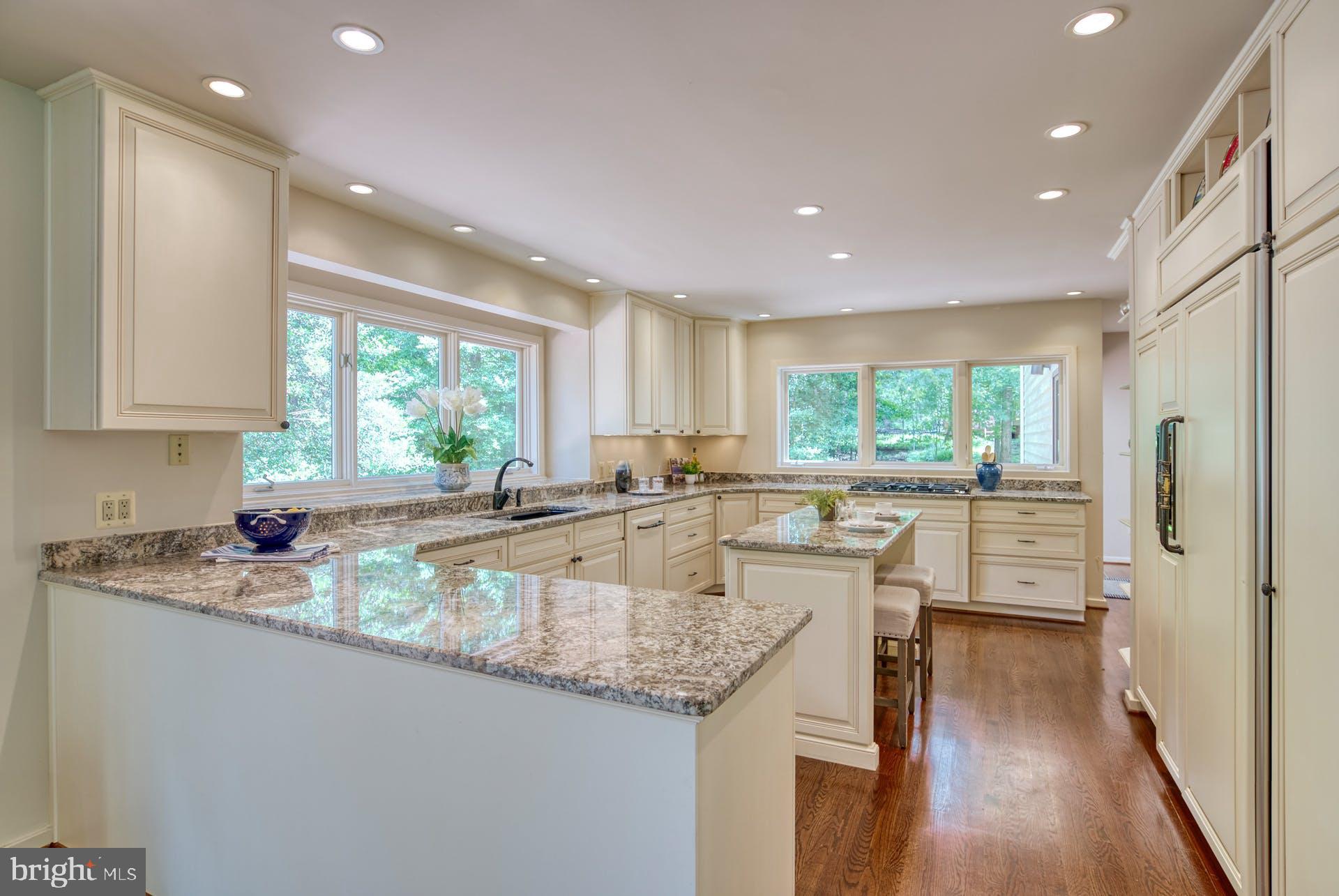 11406 Fieldstone Lane Reston, VA 20191 - Photo 18 of 58 a kitchen with granite countertop a stove a sink a refrigerator and island