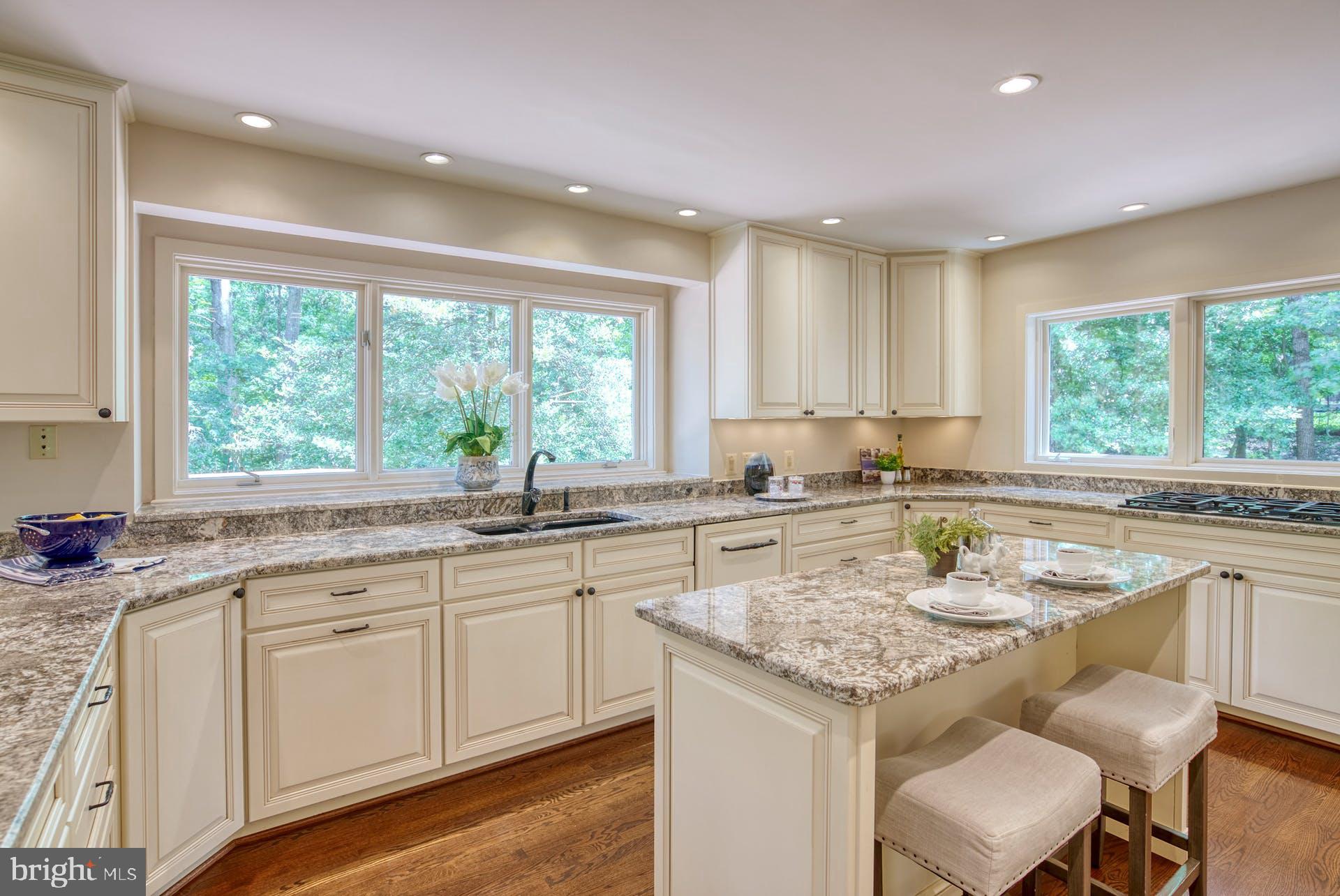 11406 Fieldstone Lane Reston, VA 20191 - Photo 19 of 58 a kitchen with a sink window and cabinets