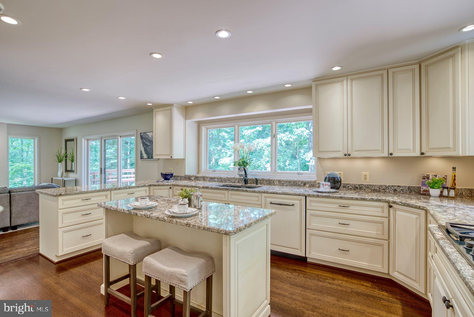 11406 Fieldstone Lane Reston, VA 20191 - Photo 20 of 58 a kitchen with white cabinets stove and sink