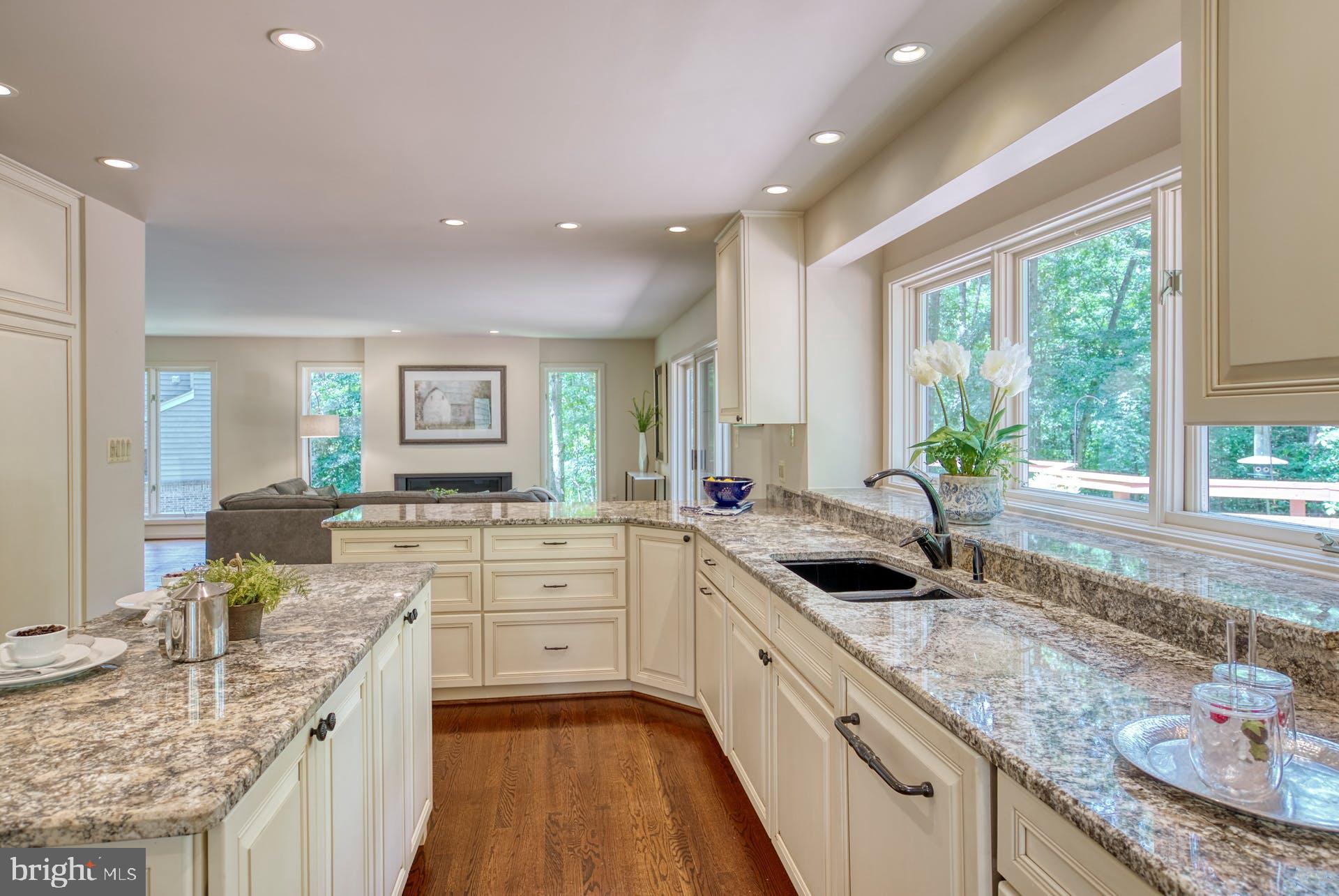 11406 Fieldstone Lane Reston, VA 20191 - Photo 21 of 58 a large kitchen with granite countertop a large counter top sink and cabinets