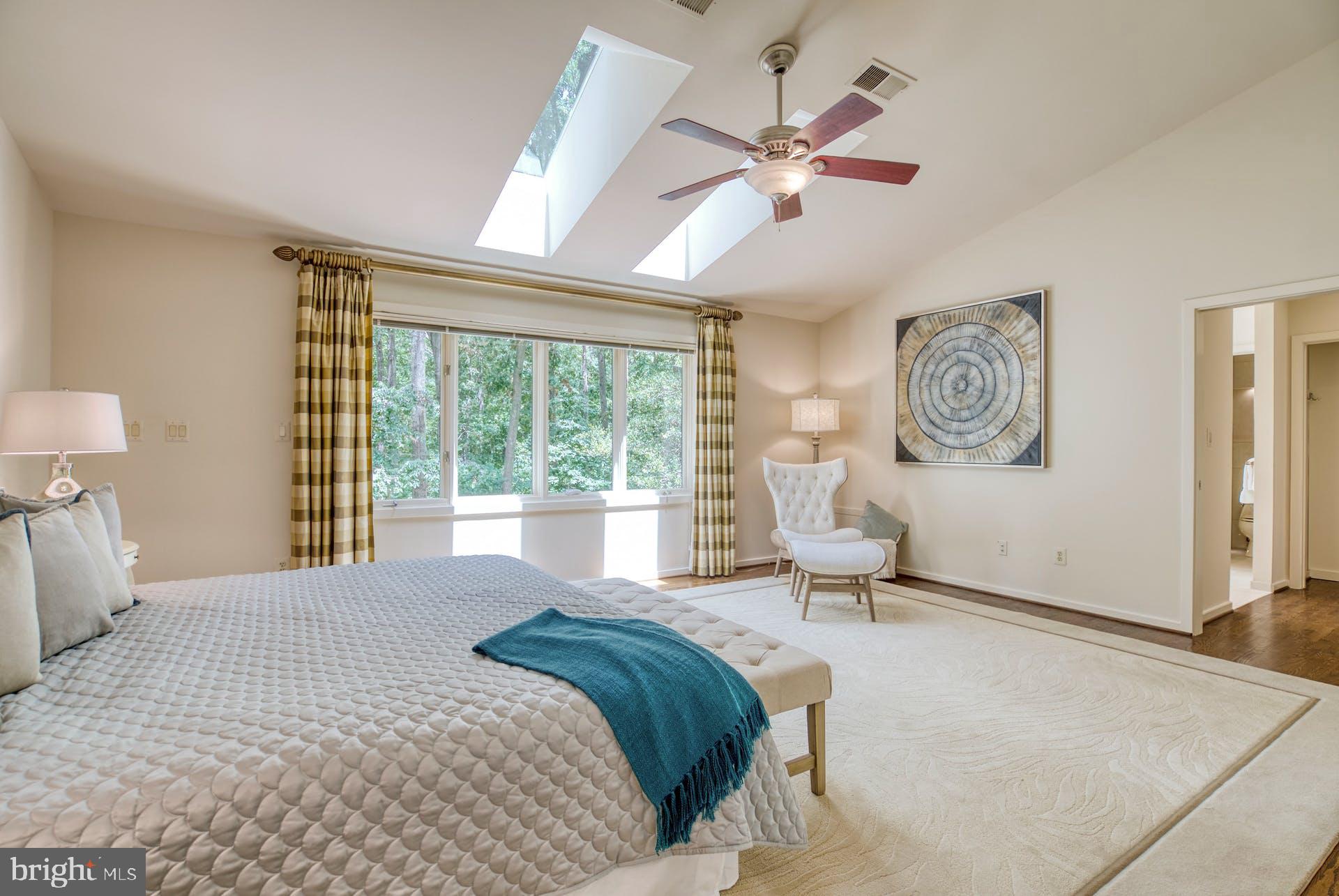 11406 Fieldstone Lane Reston, VA 20191 - Photo 29 of 58 a spacious bedroom with a large bed and a chandelier