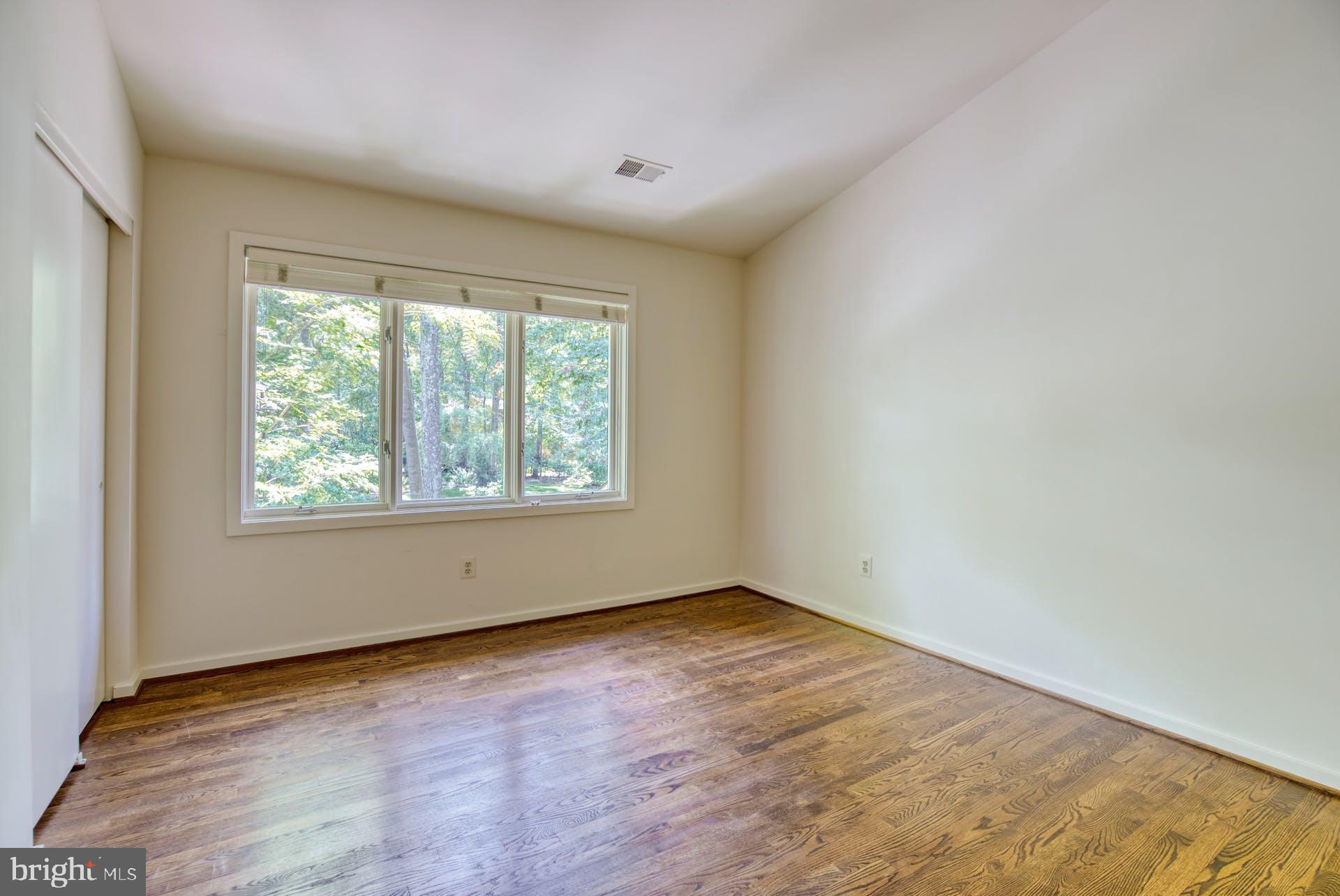 11406 Fieldstone Lane Reston, VA 20191 - Photo 39 of 58 an empty room with wooden floor and windows