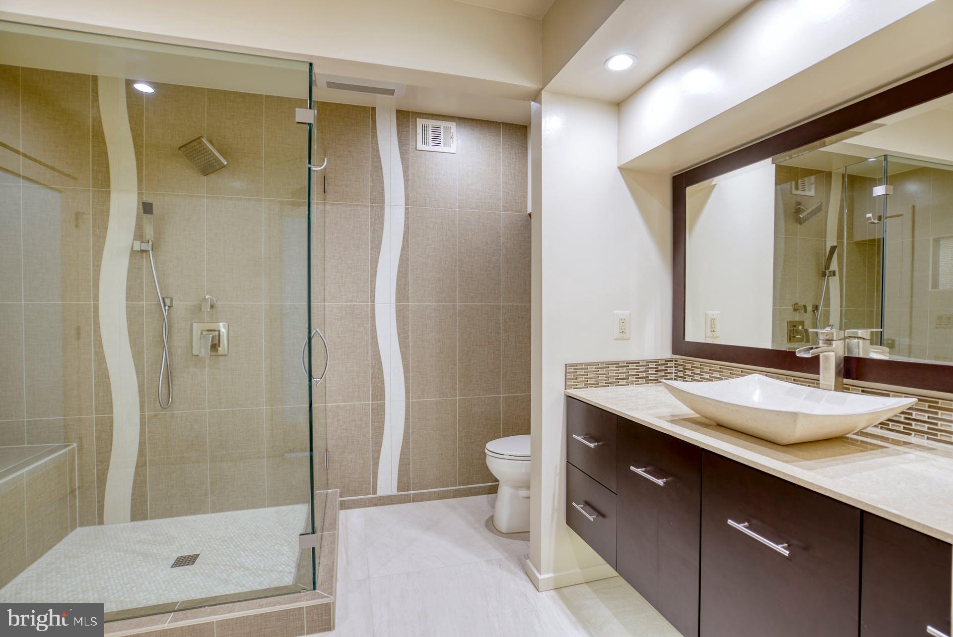 11406 Fieldstone Lane Reston, VA 20191 - Photo 49 of 58 a bathroom with a granite countertop sink toilet and shower