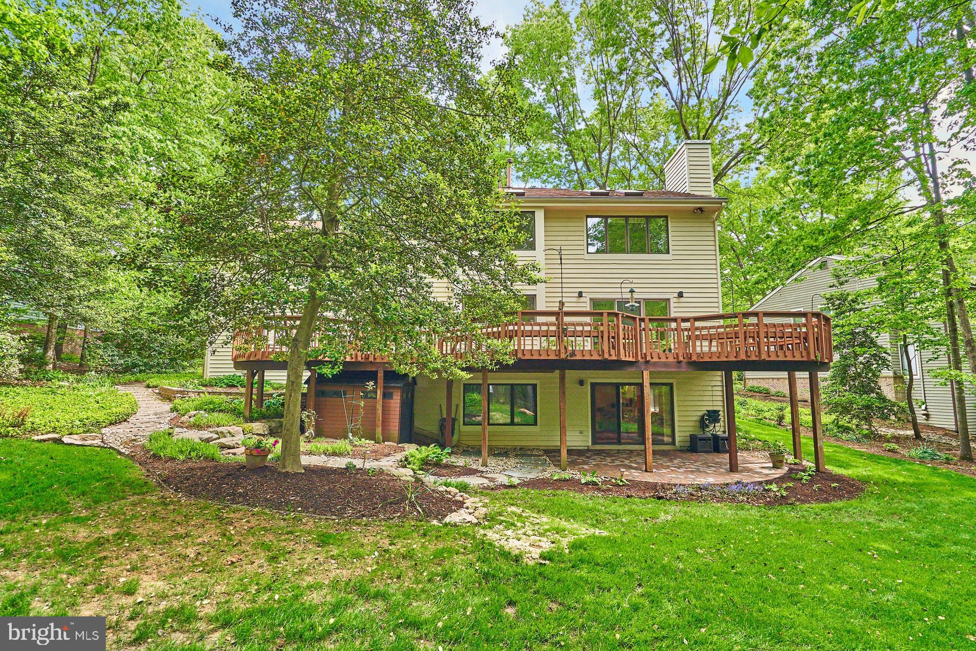 11406 Fieldstone Lane Reston, VA 20191 - Photo 52 of 58 a front view of a house with a yard table and chairs