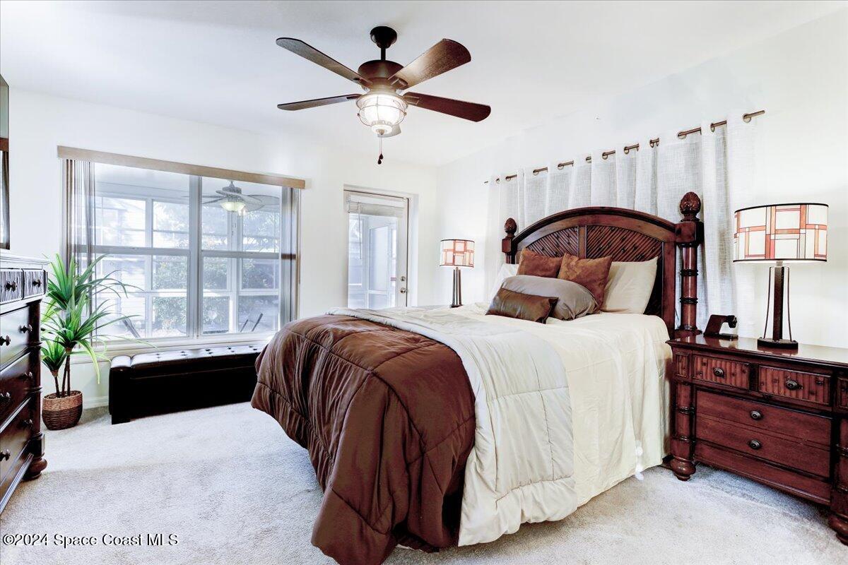 300 Sharon Drive Melbourne, FL 32935 - Photo 13 of 35 a bedroom with a large bed and a window