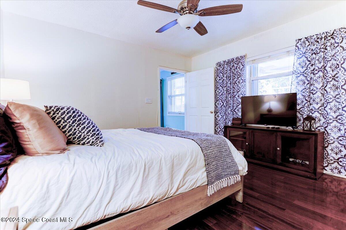 300 Sharon Drive Melbourne, FL 32935 - Photo 30 of 35 a bedroom with a bed and a flat screen tv