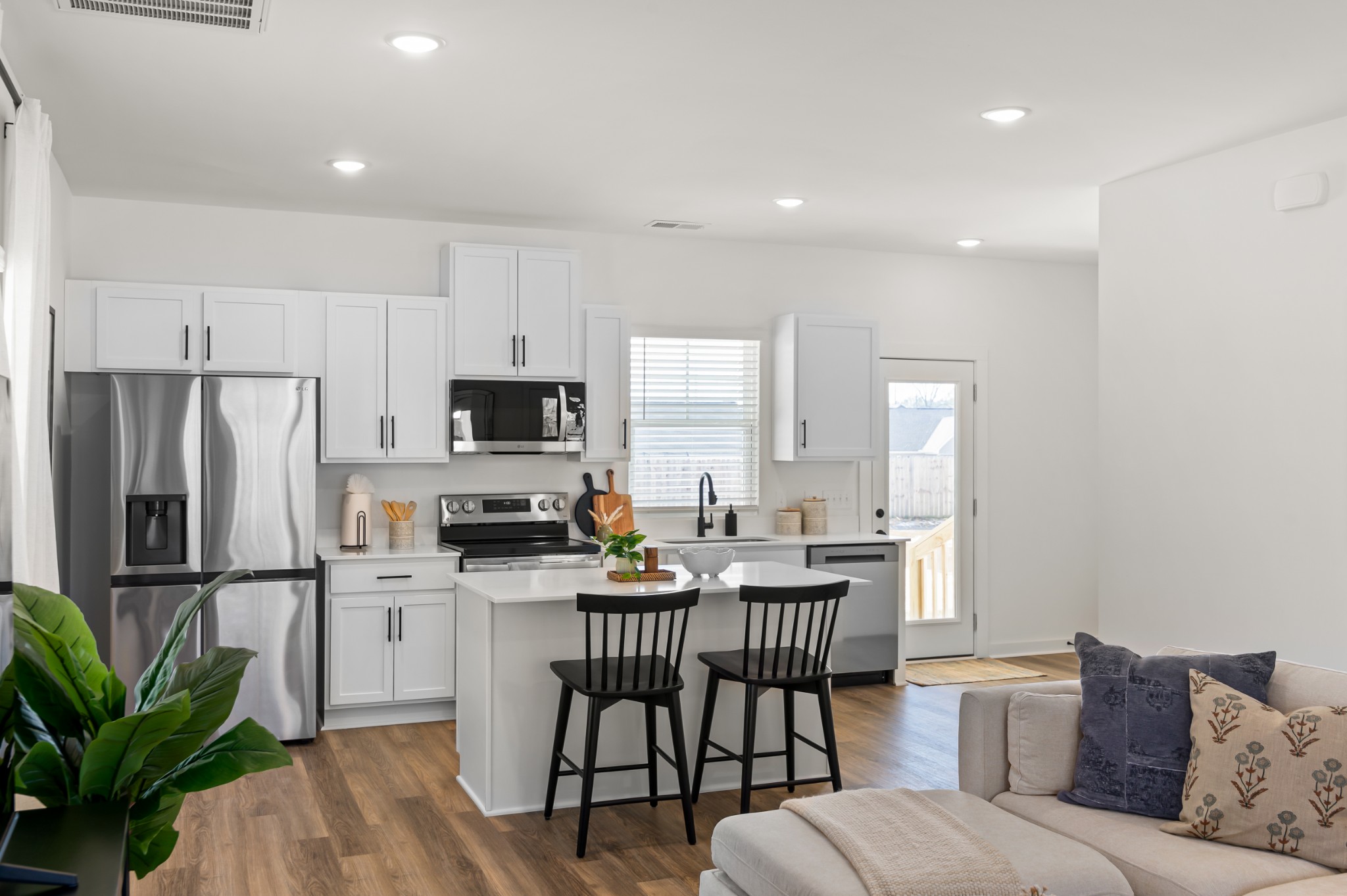 218 Reece Road Baxter, TN 38544 - Photo 7 of 16 a kitchen with granite countertop a refrigerator and a stove top oven