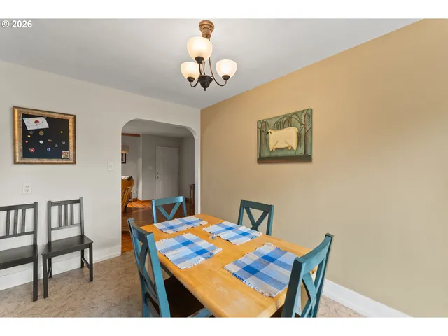 a view of a dining room with a table and chairs