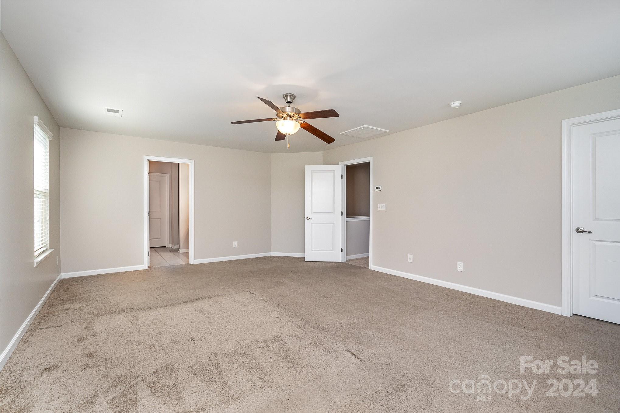 2005 Clover Hill Road Indian Trail, NC 28079 - Photo 11 of 19 a view of an empty room with a ceiling fan