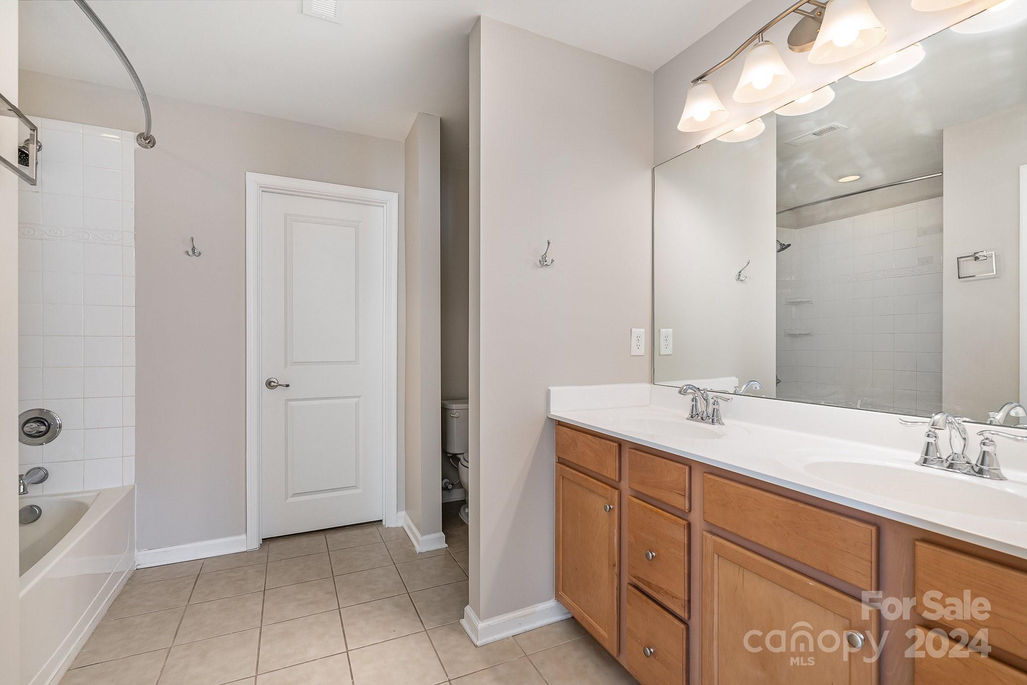 2005 Clover Hill Road Indian Trail, NC 28079 - Photo 12 of 19 a spacious bathroom with a double vanity sink a mirror and a bathtub