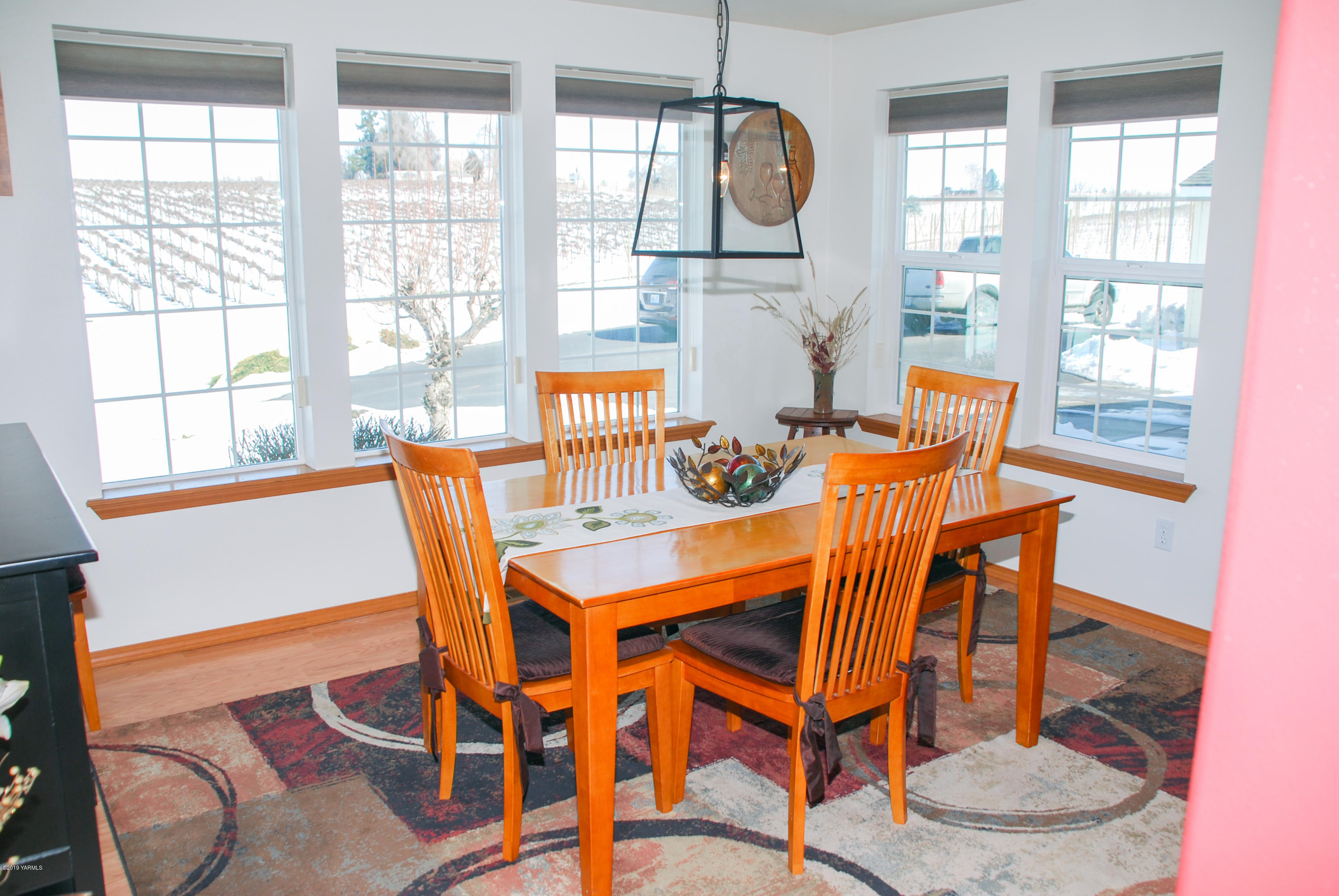 1271 North Granger Road Zillah, WA 98953 - Photo 13 of 30 a dining room with furniture a chandelier and wooden floor