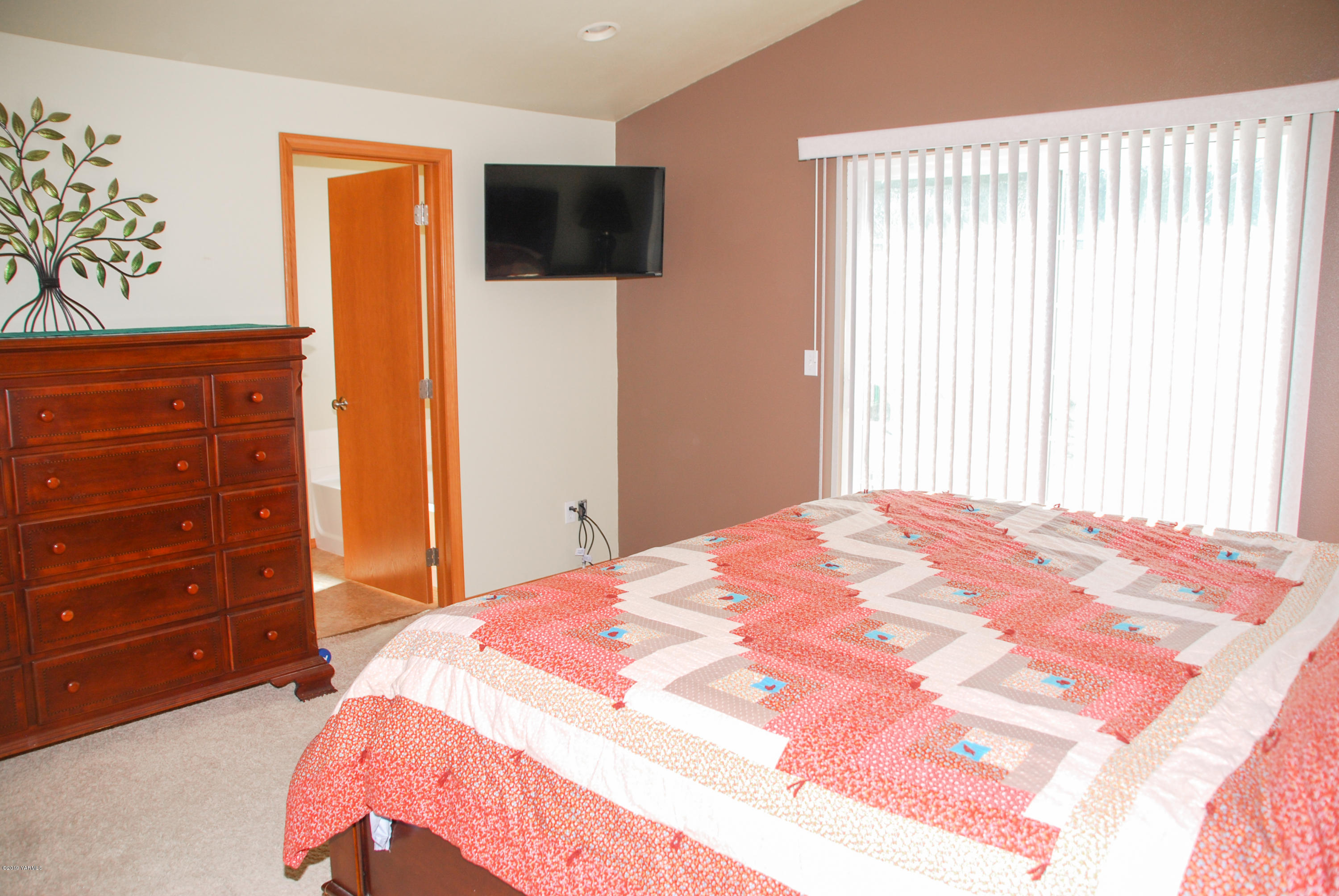 1271 North Granger Road Zillah, WA 98953 - Photo 16 of 30 a bedroom with a bed and a flat tv screen on dresser